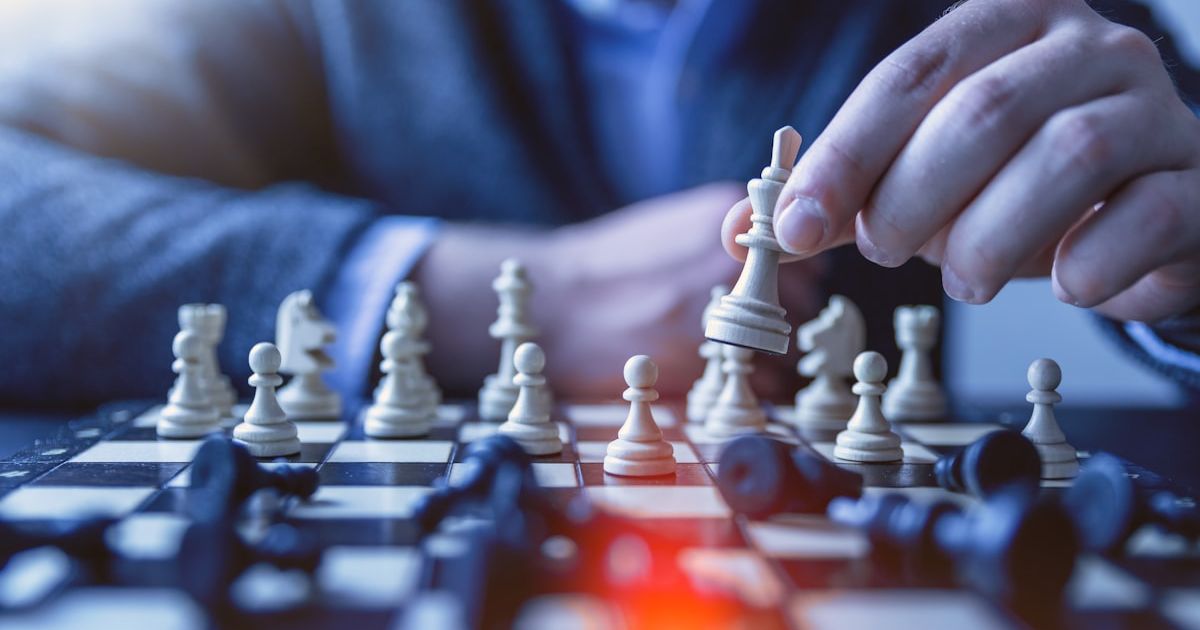 depth of field photography of man playing chess